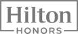 The image shows the Hilton Honors logo, featuring the brand name in bold font inside a rectangular shape.